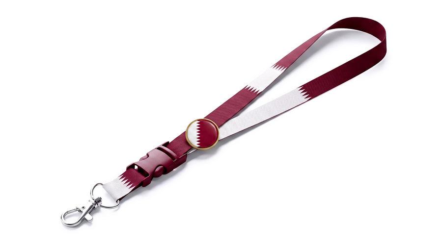 A woven Qatar flag lanyard with a metal clip and badge holder.