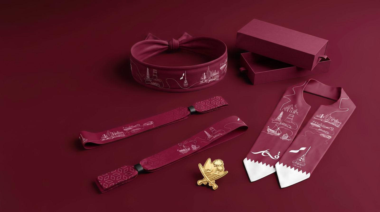 The Majd Qatar set on deep maroon: headband, wristbands, gold falcon badge, scarf and presentation box.